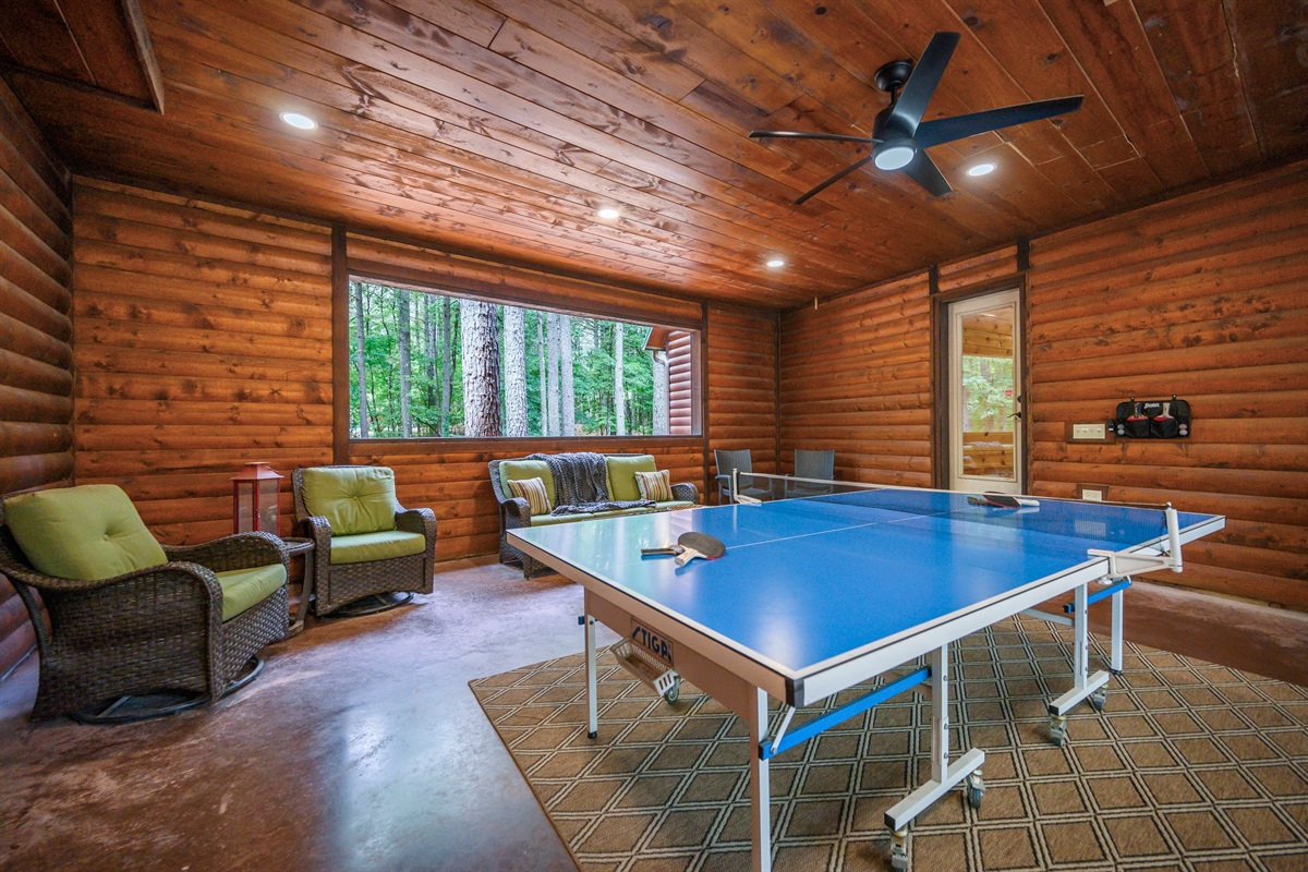 Outdoor breezeway with ping pong table and seating areas.