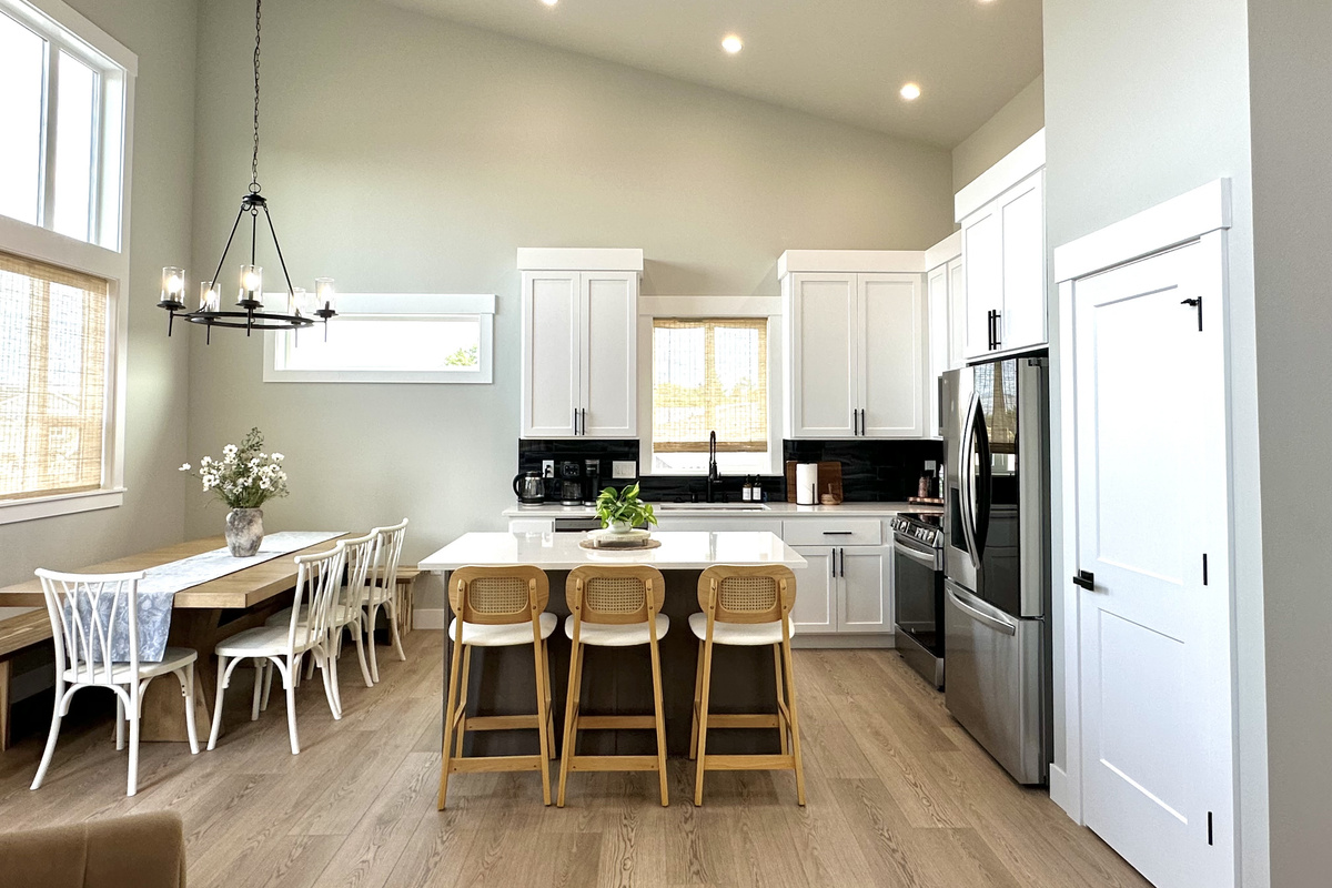 Cook Side B's dinner around the island with three stools already pulled up — pots, pans, and every gadget you'd actually reach for are already here.