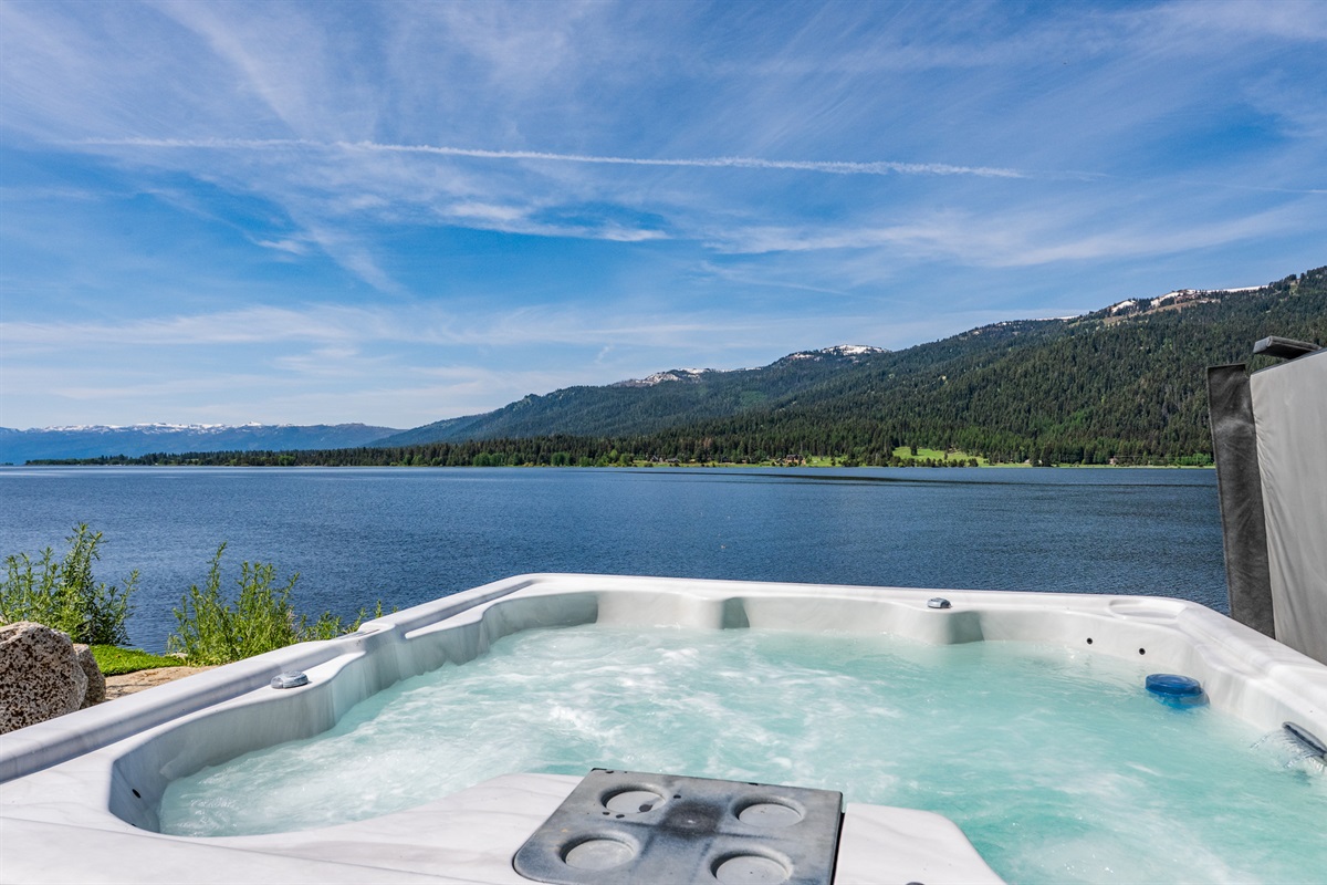 Relax in the hot tub with stunning lake and mountain views