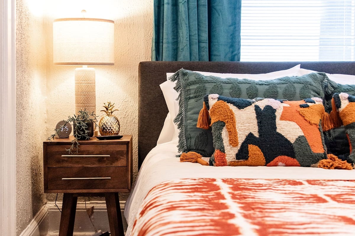Charming bedside table with a sleek design, offering convenient storage for your essentials like a lamp, books, or your phone.