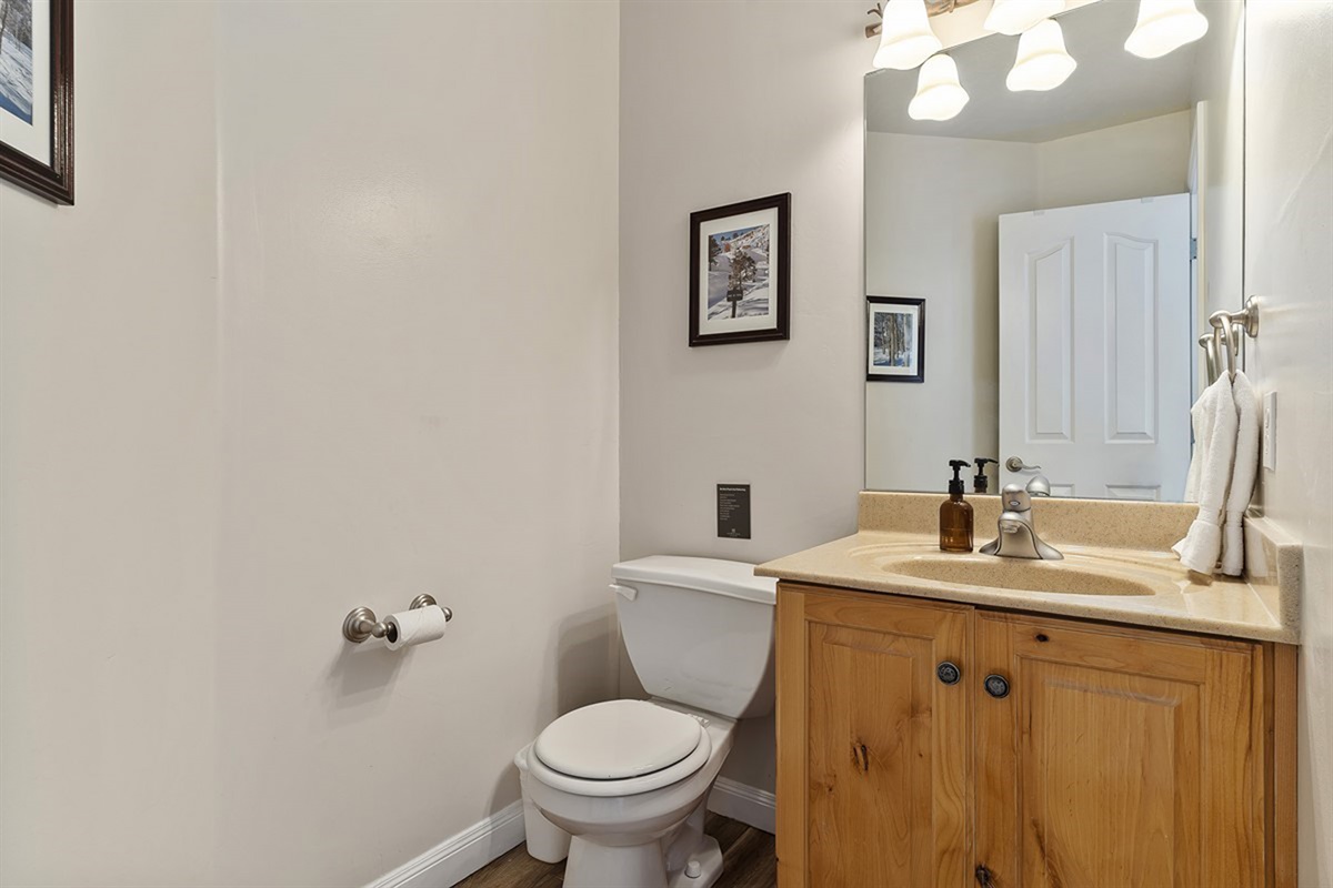 A sleek and conveniently located powder room enhances everyday ease.