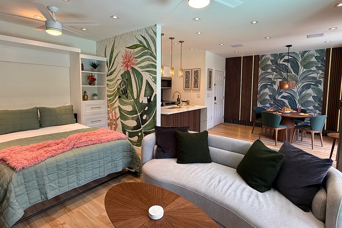 Open plan living and dining room with open Murphy bed