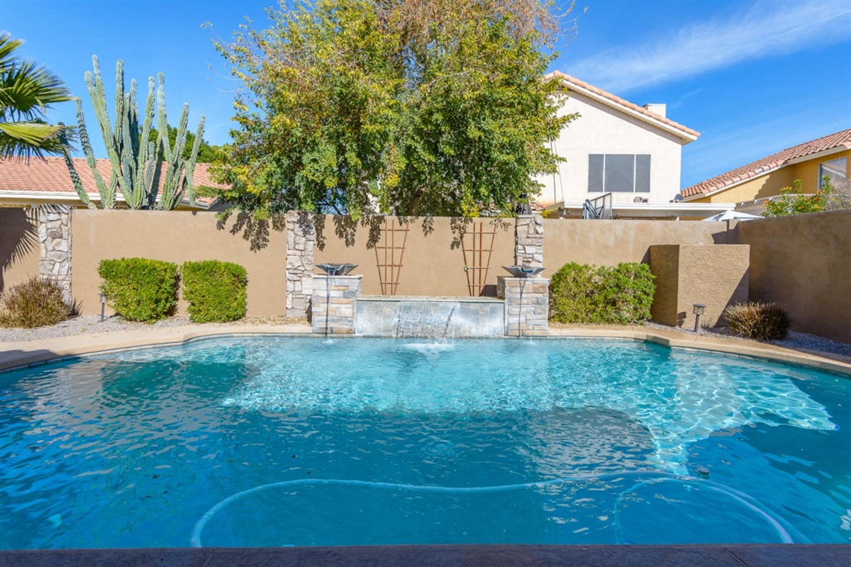 Backyard pool and spa with lounge chairs, water features, and space to enjoy the Arizona sun.