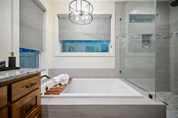 Luxury spa bathroom with soaking tub and glass walk-in shower — unwind in modern cabin comfort surrounded by forest serenity. Perfect for romantic Broken Bow getaways.