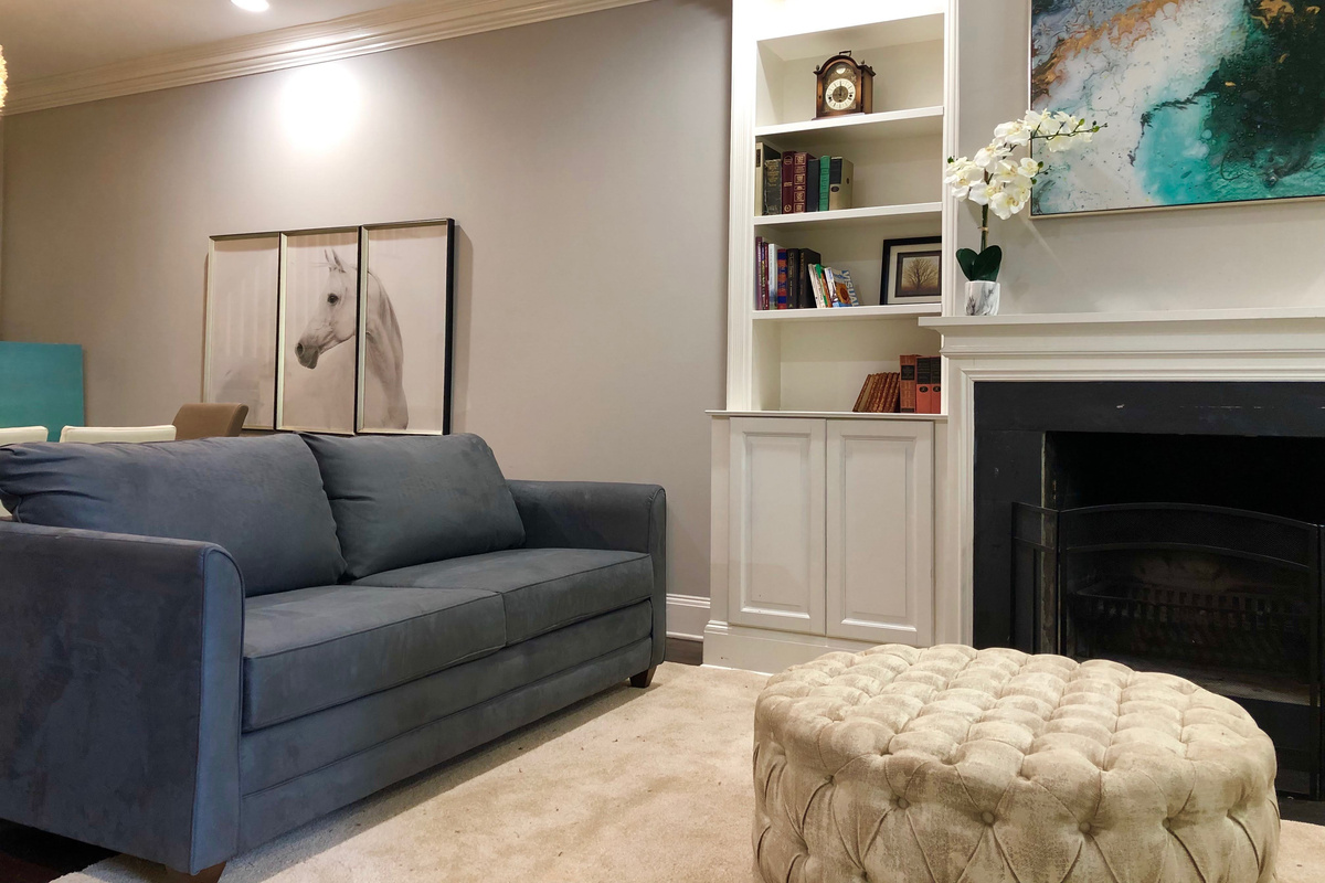 The queen sofa bed offers stylish versatility—relax during the day, unwind into comfort at night, all anchored by a tufted ottoman and elegant décor.