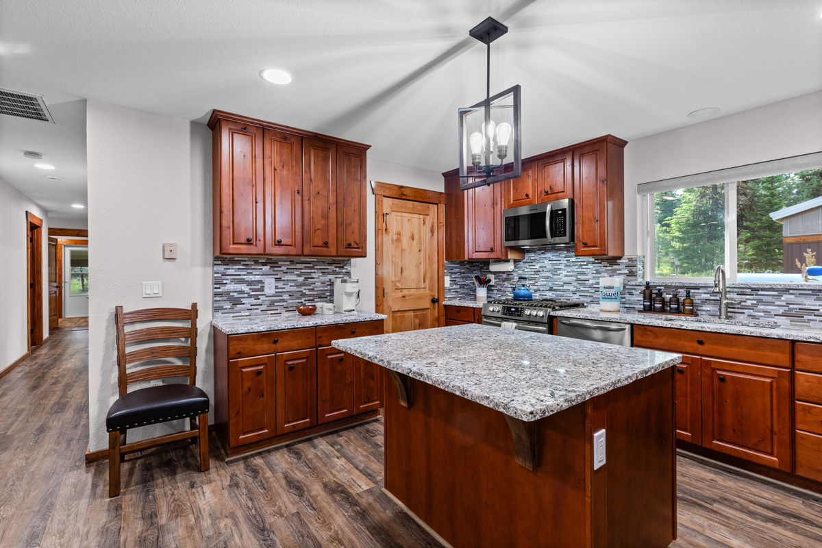 Kitchen with oven, island and refrigerator
