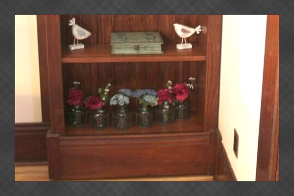 This bookcase holds a few trinkets and a secret door too!