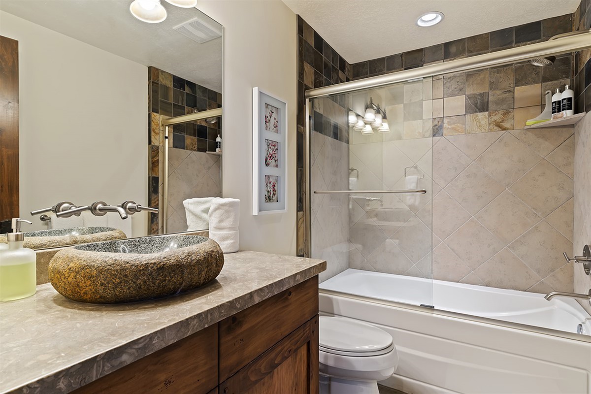 An additional full bathroom showcasing modern design elements, elegant fixtures, and a spa-like ambiance.