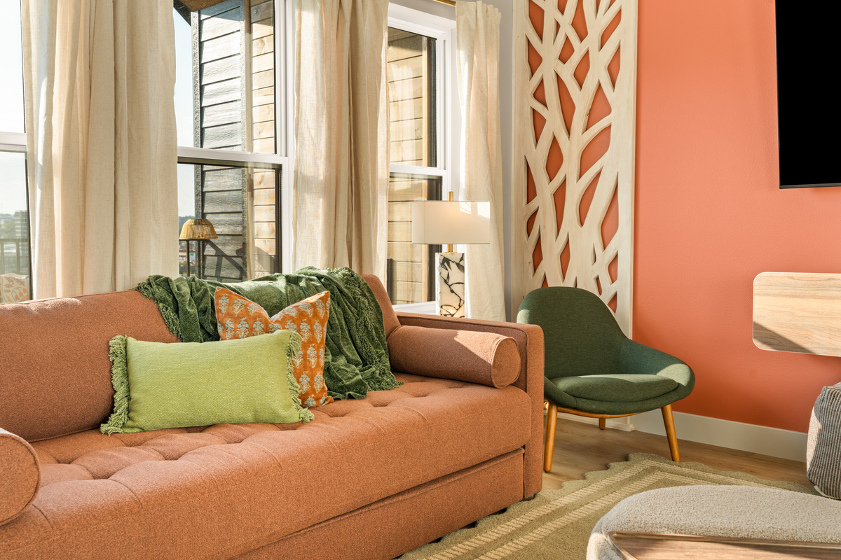 Cozy up in the sun-filled living room with comfortable seating and stylish, colorful décor.