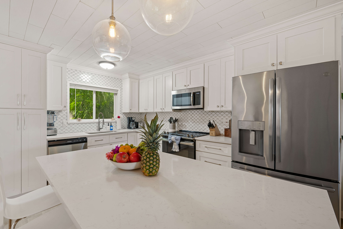 Gather around the spacious kitchen island with comfortable bar seating.