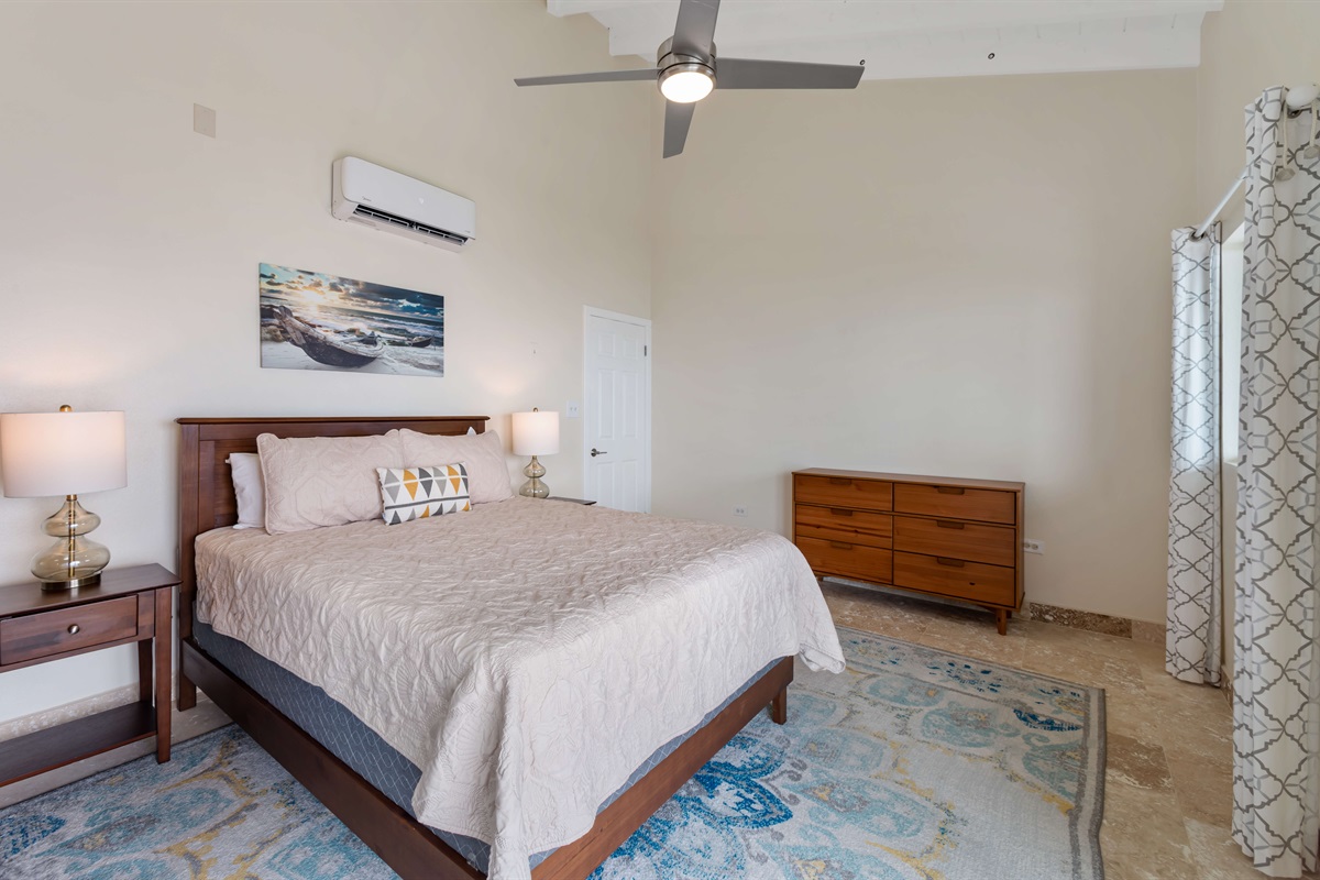 Soft linens and airy decor create a restful retreat in this guest room.