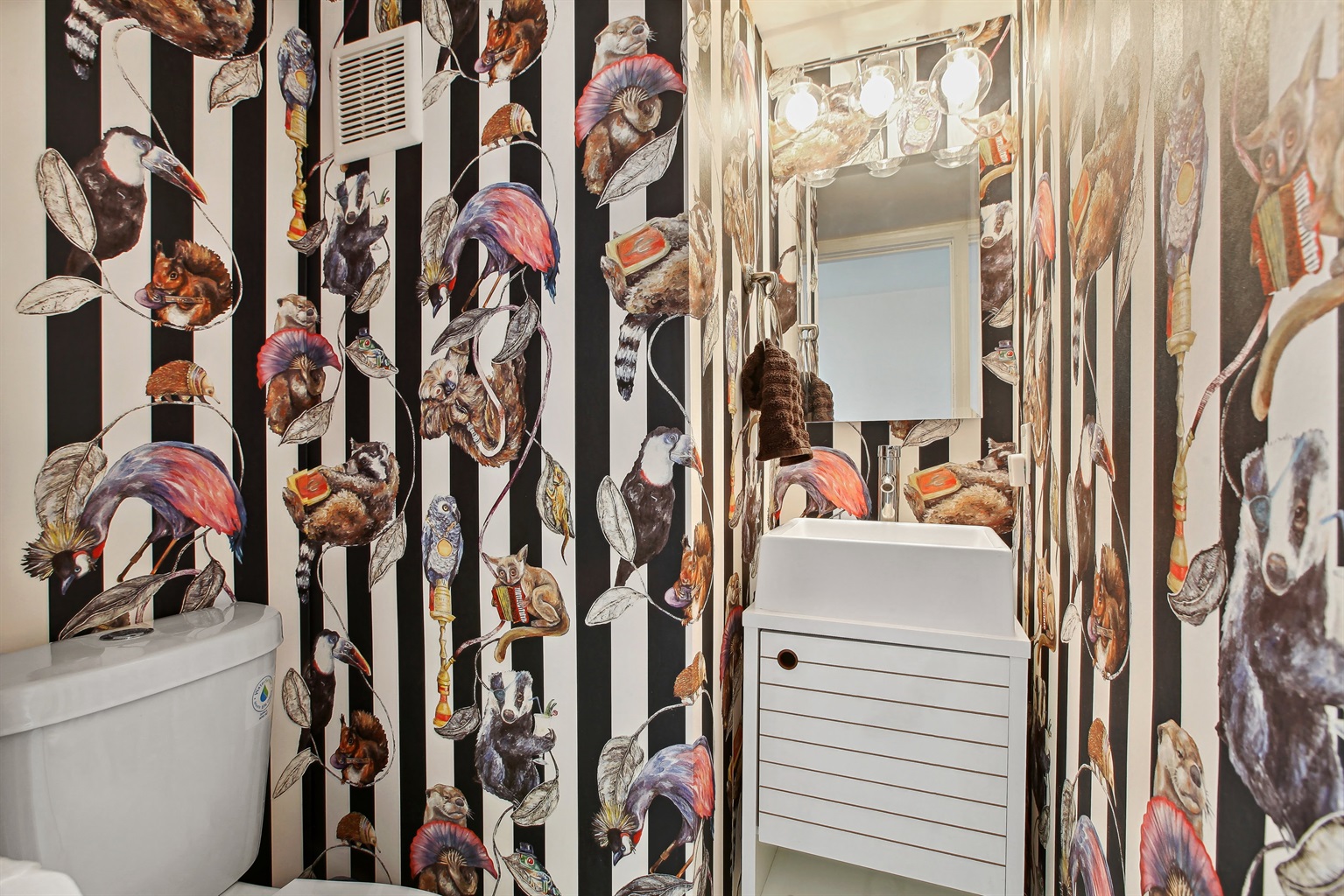 There is a half bathroom in the hallway next to the kitchen on the lower level