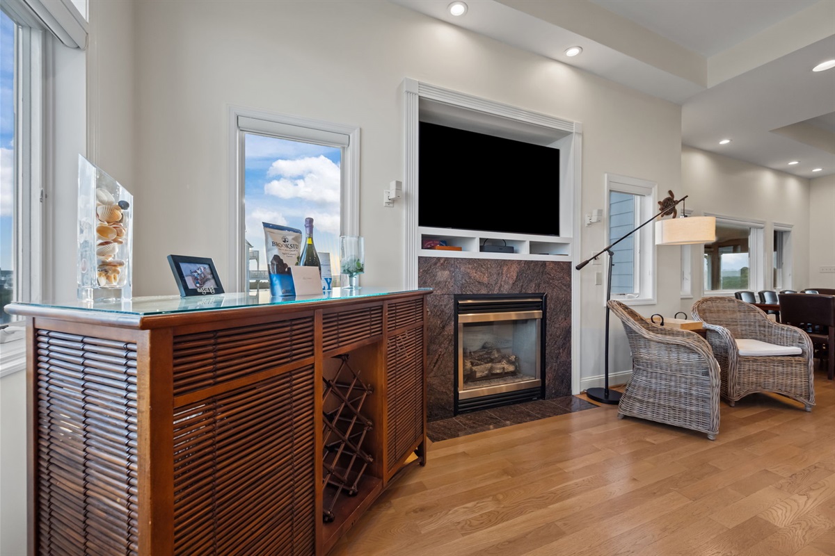 Cozy living area with fireplace and smart TV&mdash;perfect for relaxing after a day at the beach