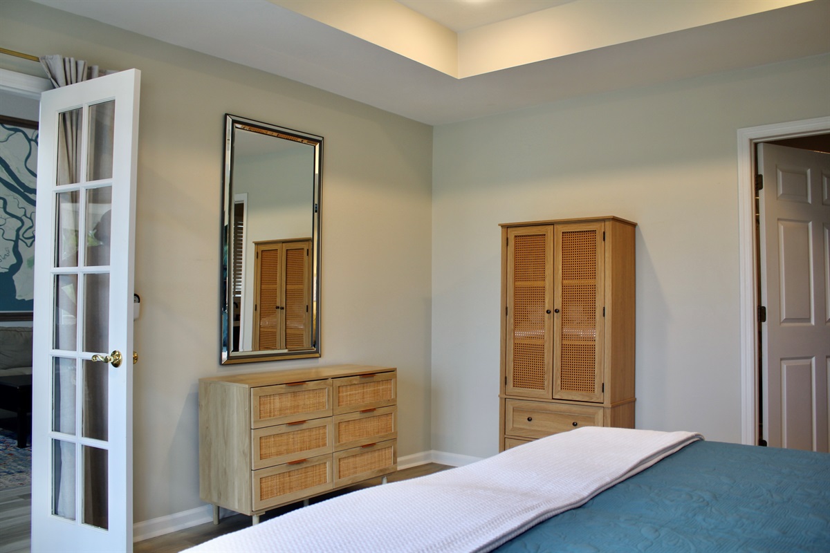 Thoughtful details like rattan furnishings and tray ceilings create a warm, elevated escape.