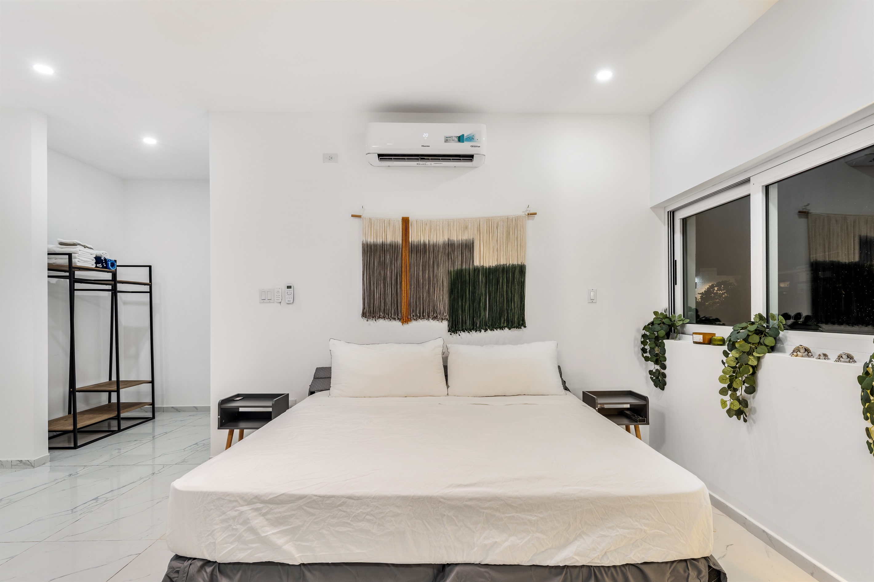 Another primary suite angle showing open closet and bed