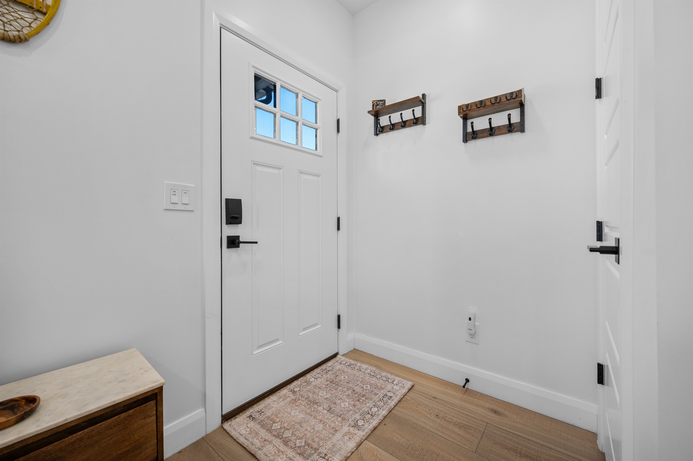 Entryway with hall hooks and welcoming décor.