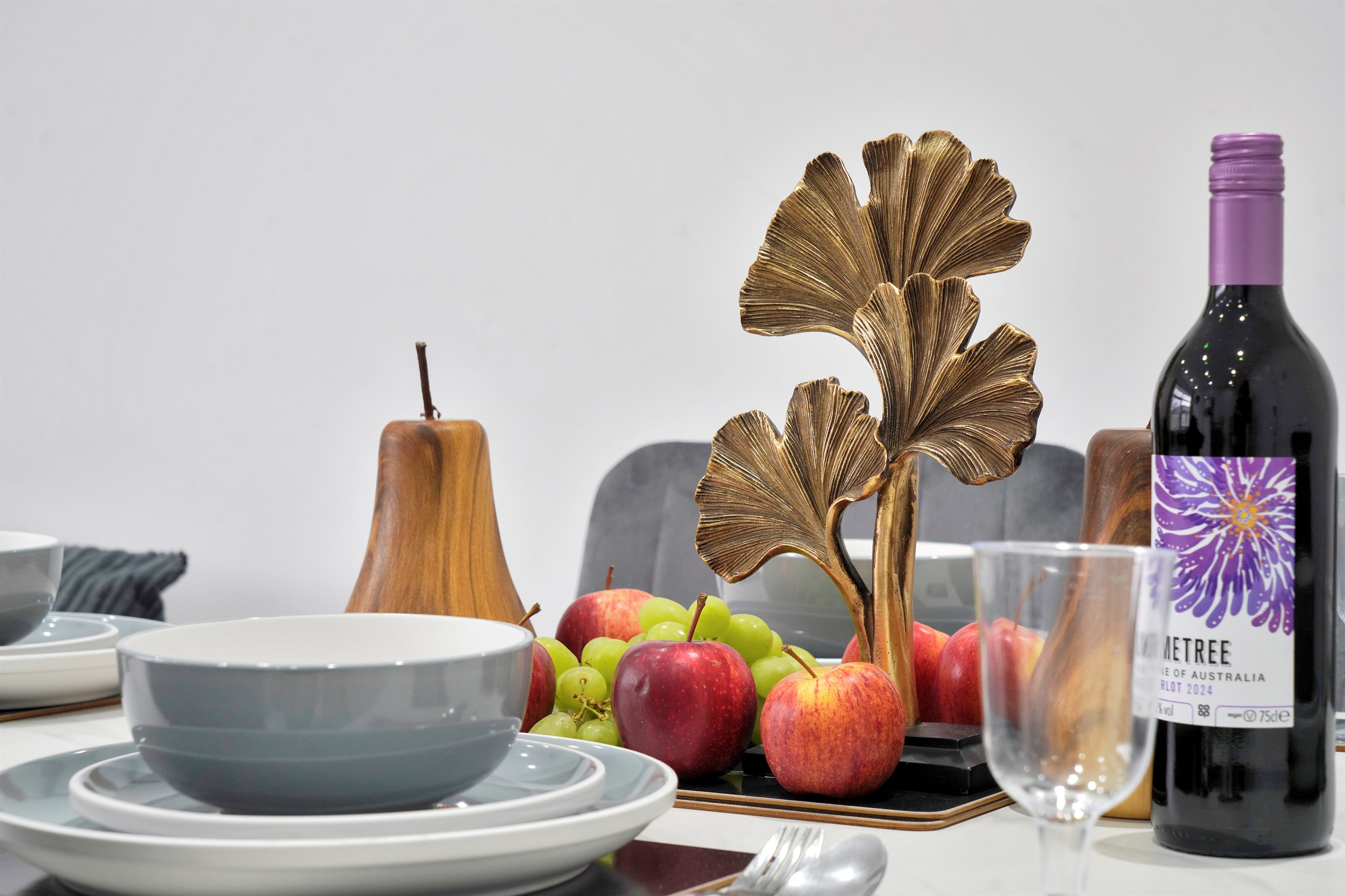 [table set for meals, wine glasses, dining space]