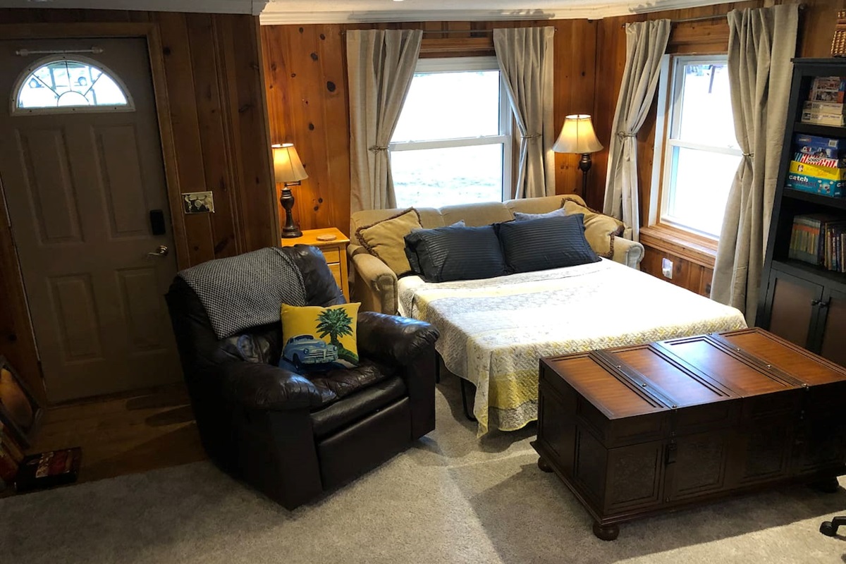 Sofa bed in action! Extra pillows and linens are stored in chest.