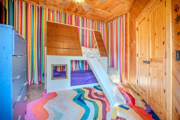 Our kids' room offers a fun bunk bed with slide and private en suite bath with a tub that's perfect for bath time. 