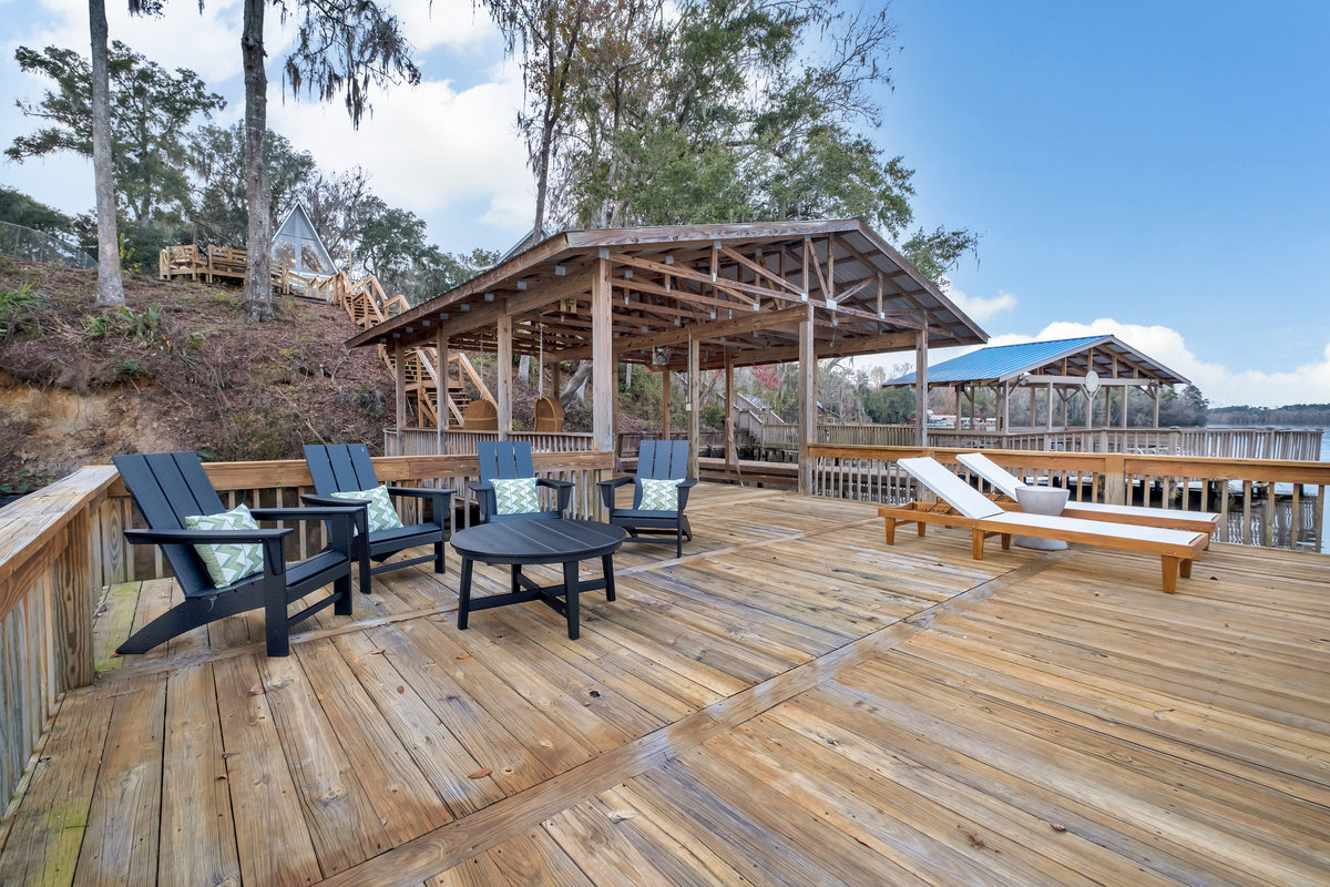 Adirondack chairs and loungers at the water's edge