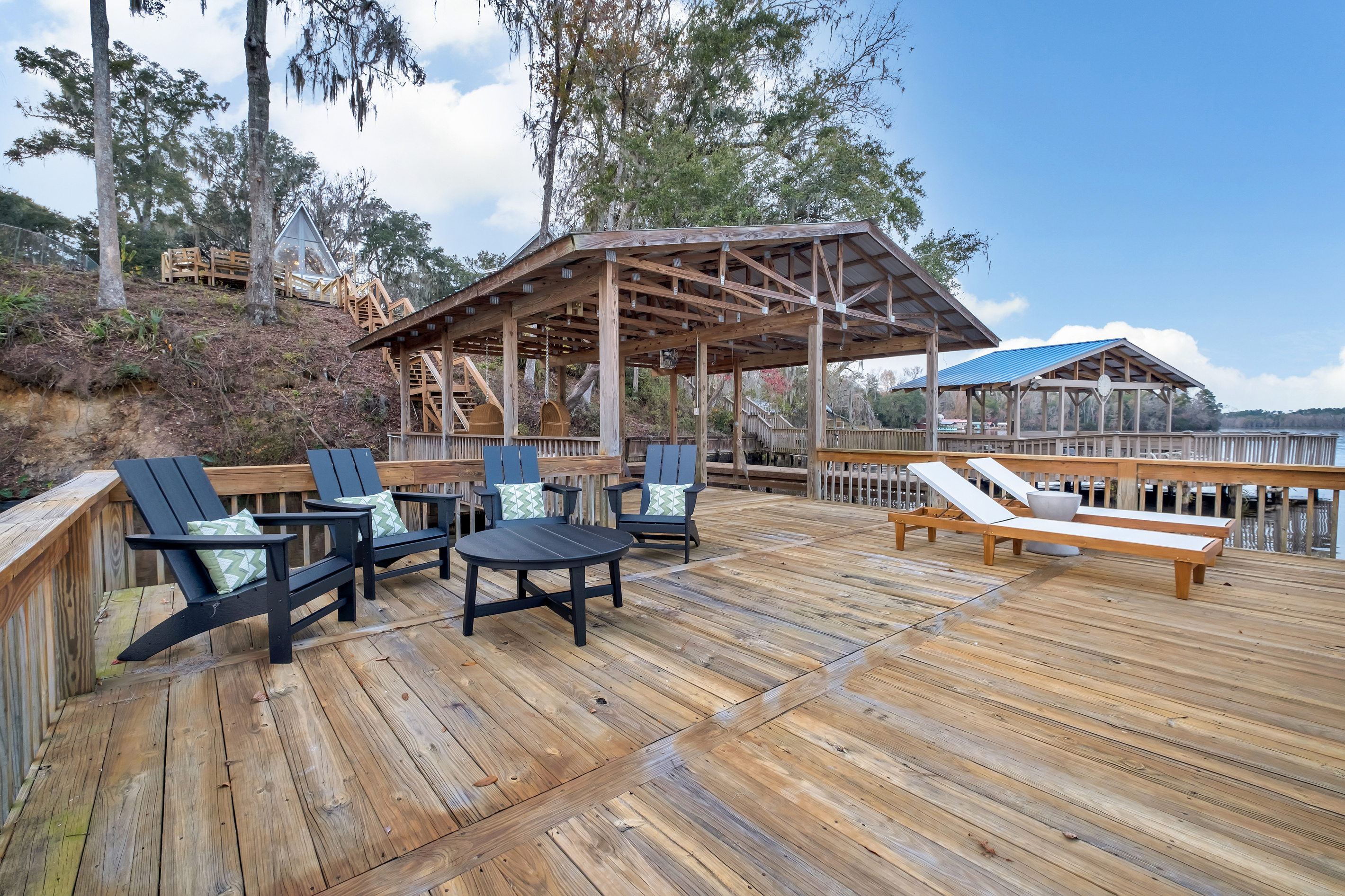 Adirondack chairs and loungers at the water's edge