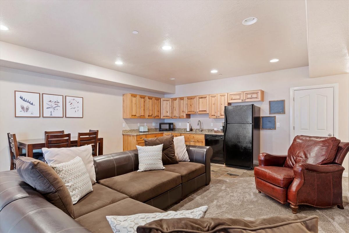 An open-concept lower-level living and kitchen space designed for convenience and connection, blending comfort with functionality.