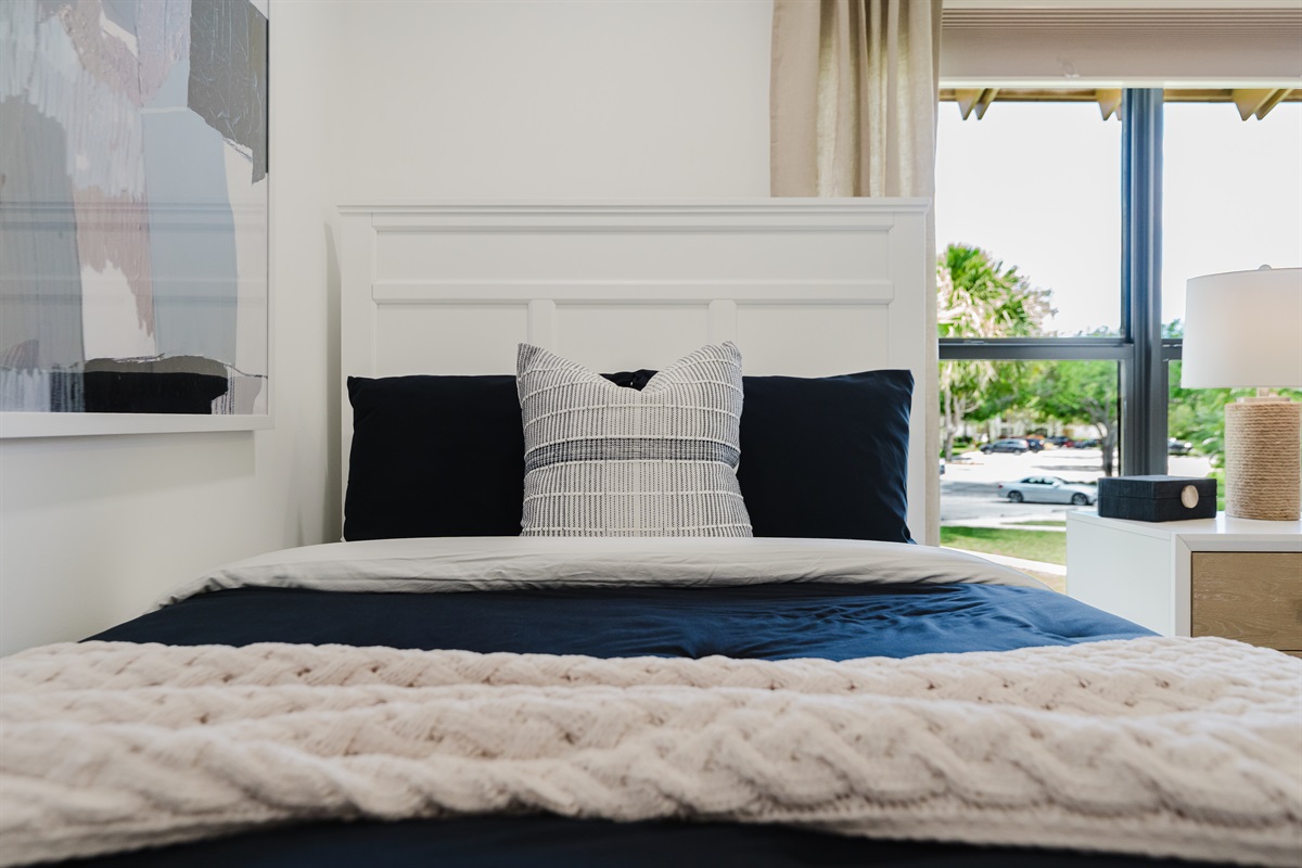 Cozy guest double queen bedroom with comfortable bedding and ample storage. Perfect space for family or friends to unwind and relax. Bright and inviting guest room with stylish touches.
