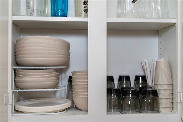 Fully stocked cabinet with dinnerware and glassware