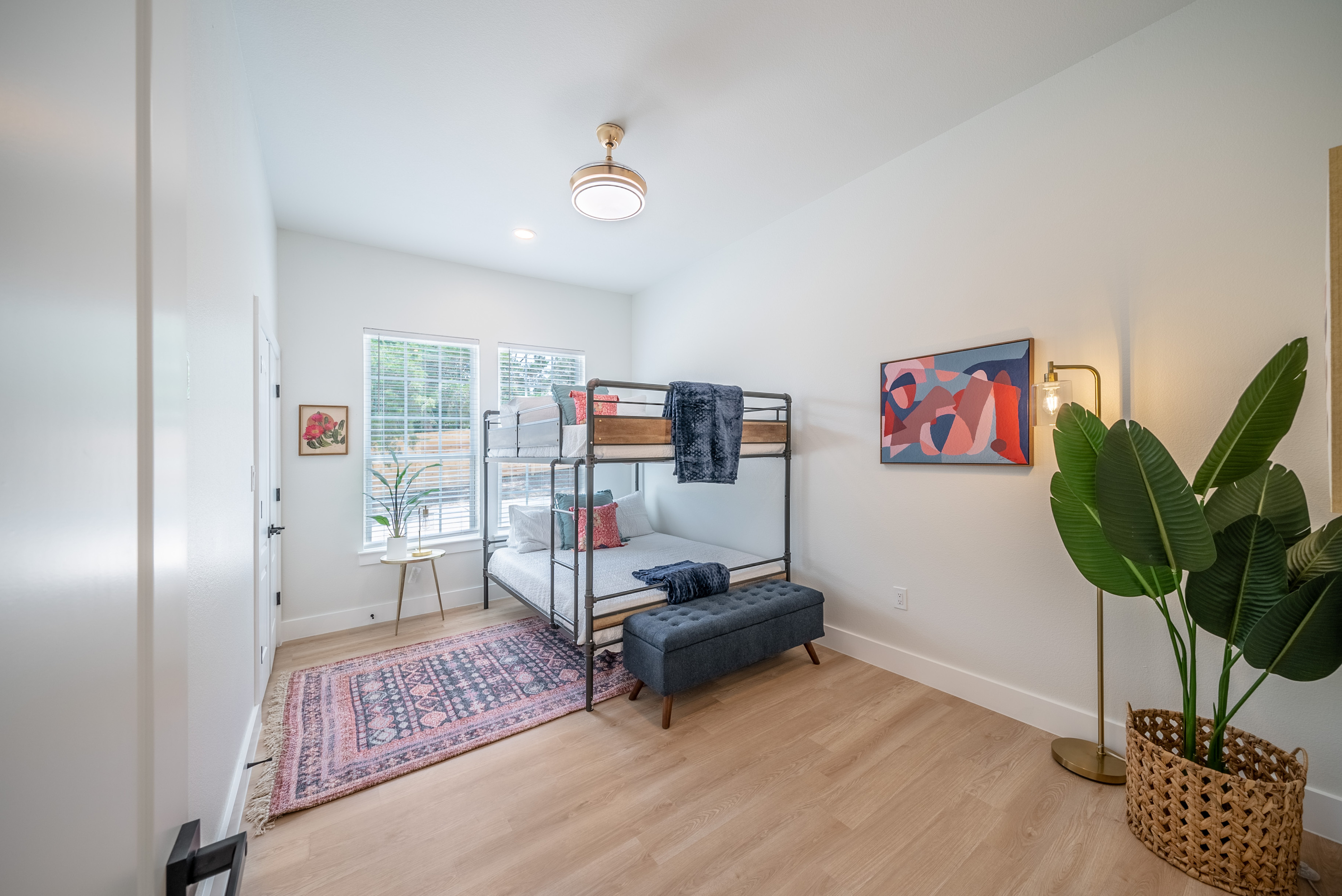 Primary suite sitting area featuring a cozy daybed and lush greenery.