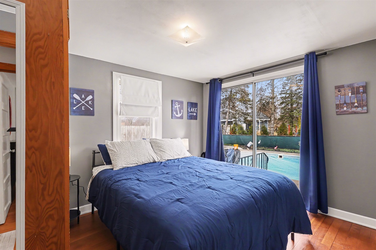 Bedroom #1 with slider to the backyard and pool