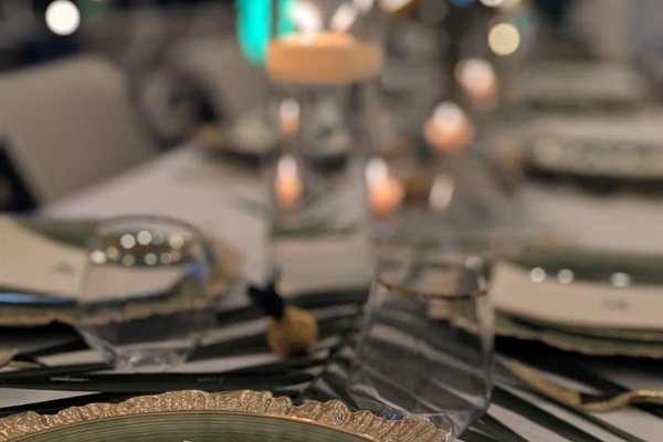 Tables, chairs, multiple pieces of place setting provided