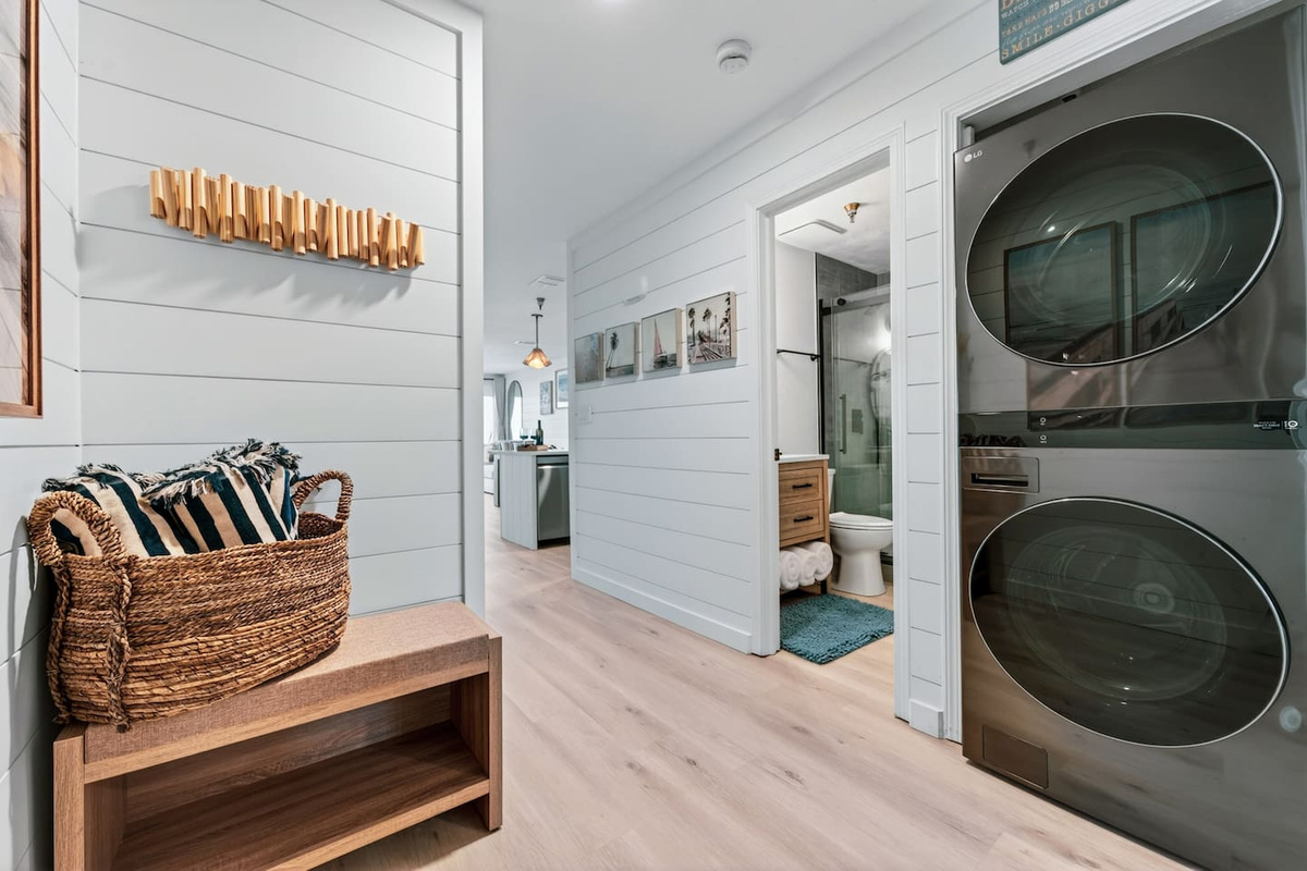 Modern stackable washer and dryer with complimentary detergent for added convenience during your beach vacation