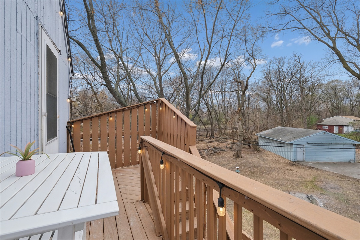 Enjoy the view from the backyard deck! There's a train track just behind the trees for those who love trains!