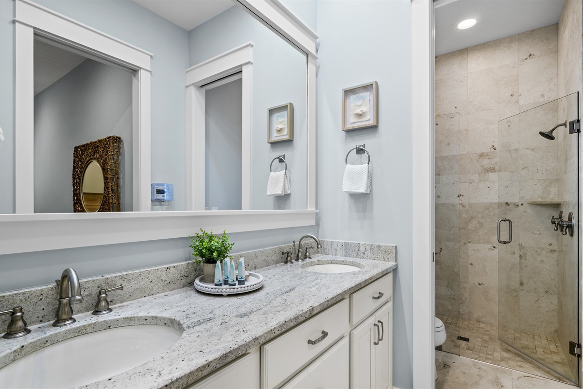 Luxury bath with dual sinks and a walk-in shower.