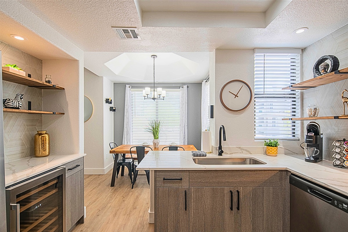 Bright and modern kitchen with an adjacent dining space ideal for enjoying home-cooked meals.