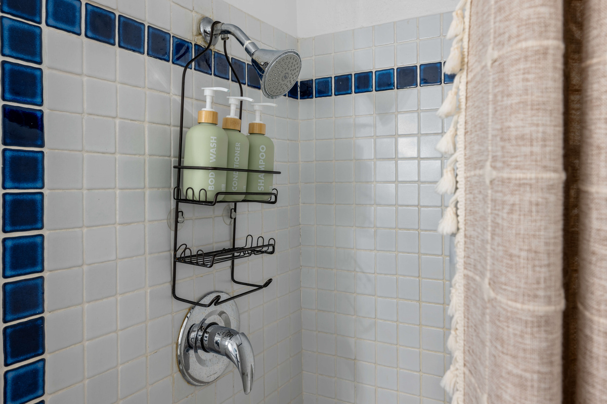 Modern finishes and a spacious shower create a relaxing experience.