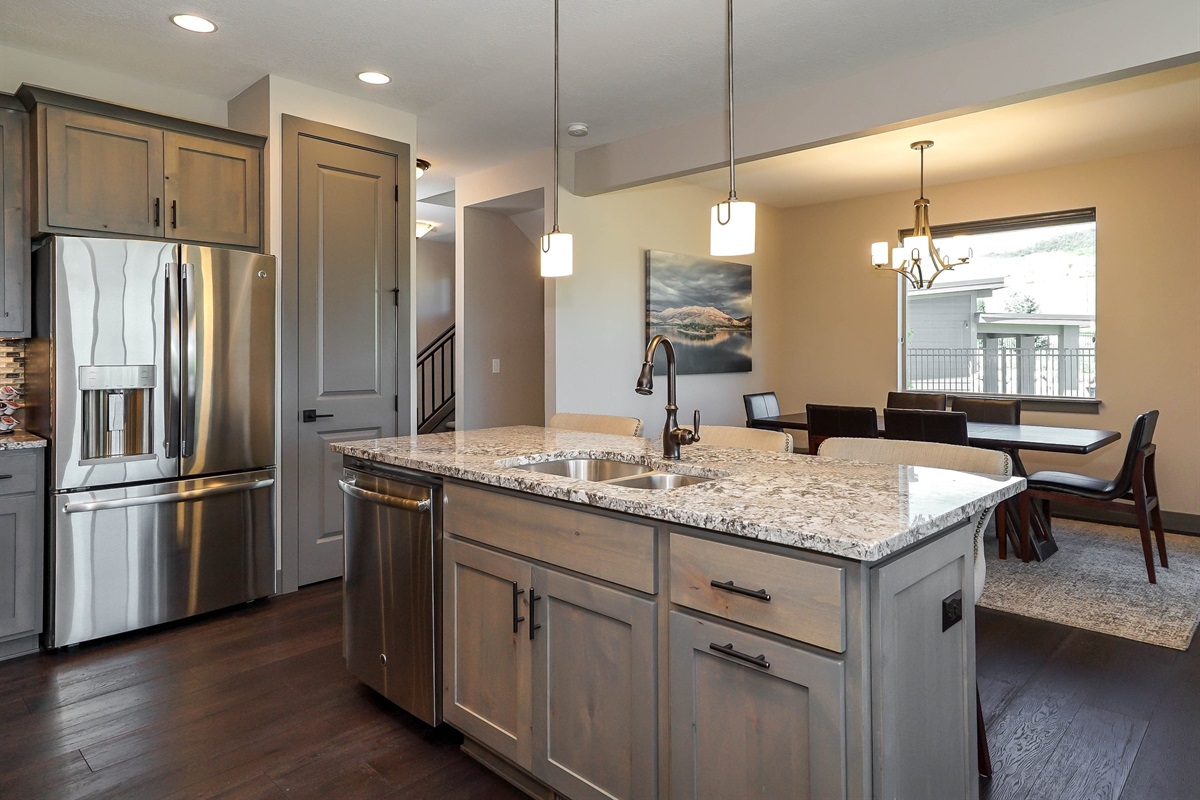 Fully equipped kitchen with stainless steel appliances and ample space.