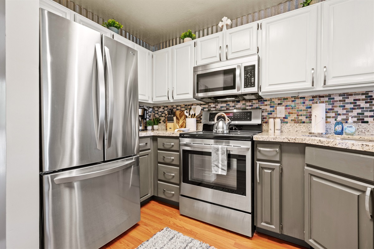 Stainless-steel appliances and custom backsplash for a modern mountain feel.