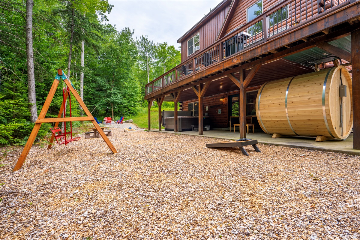 Your private backyard retreat features a charming swing and a firepit