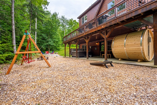 Your private backyard retreat features a charming swing and a firepit