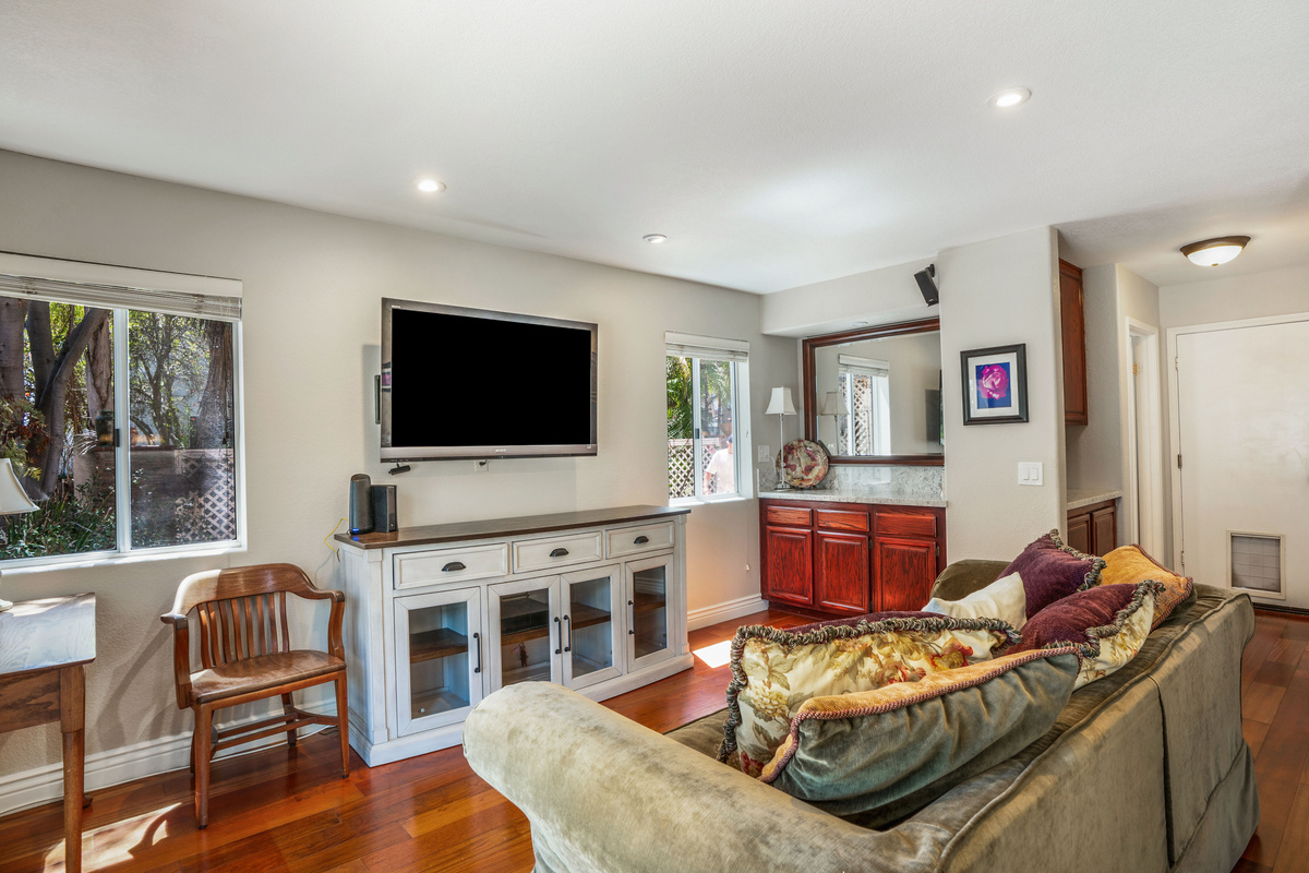 Family Room with Door Leading into Half Bathroom, Garage, & Laundry Area