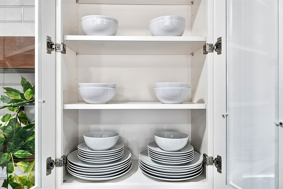 Bright white kitchen with a sleek, extended layout and ample counter space. The long layout offers plenty of countertop space, perfect for cooking, prepping, and everyday meals. Fully stocked with everything you need for a comfortable stay!
