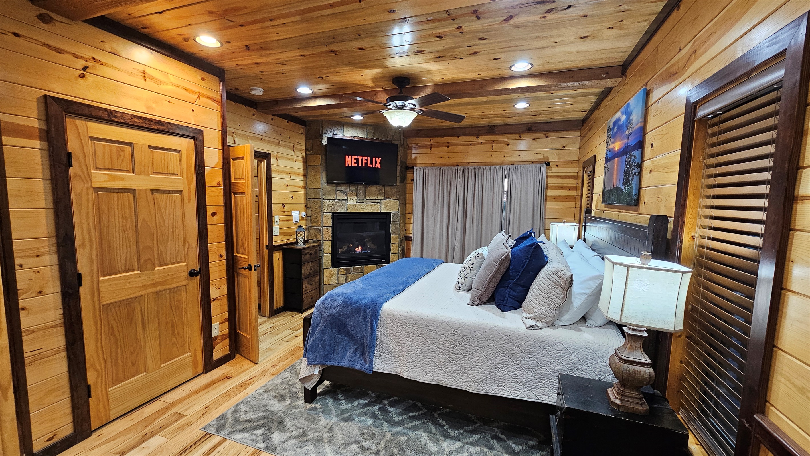 King suite with stone fireplace and Smart TV—your cozy retreat after a day out.