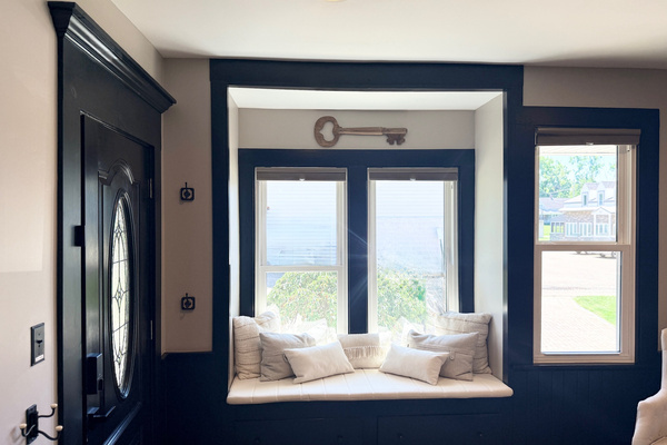 Window reading nook with soft cushions and abundant natural light.