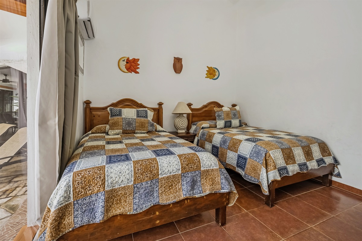 Bedroom 1 on Main Floor with Shared Bathroom and Access to Backyard