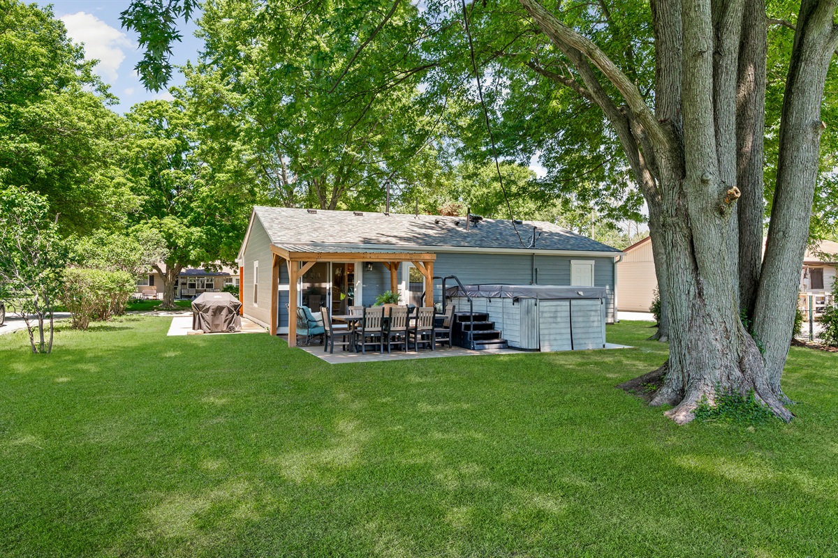 Enjoy the backyard oasis featuring a 14ft swim spa, outdoor dining for 8, grill, and comfortable seating area perfect for relaxing and spending time together.