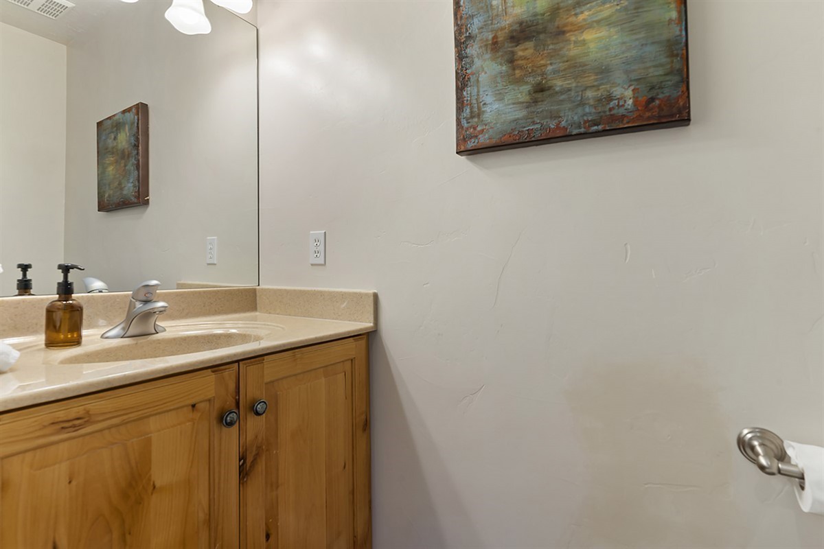 A clean, modern bathroom with a stylish vanity and warm finishes, providing a fresh and inviting space.