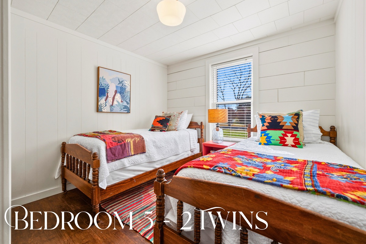 Head into this twin bedroom where colorful bedding and multiple sleeping options create a fun and practical setup for guests of all ages.