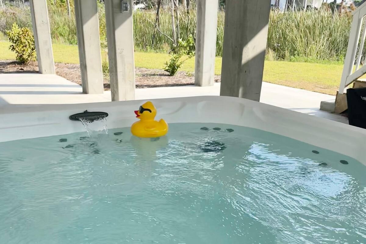 Unwind in the brand-new hot tub for your perfect coastal getaway.