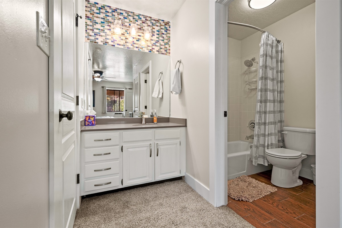 Beautifully updated bathroom with double vanity and bright lighting.